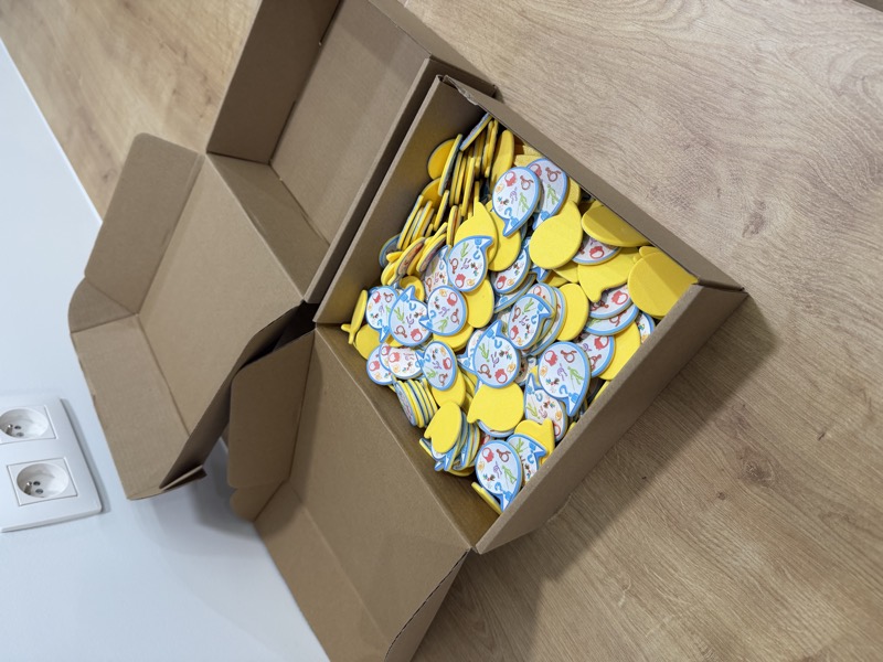 Cardboard boxes filled with printed yellow tokens